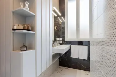 a bathroom with a sink and a mirror at The Romulus in Rome