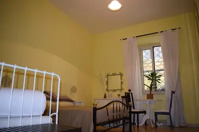 a bedroom with a bed and a window and a table at Boezio43B&B in Rome