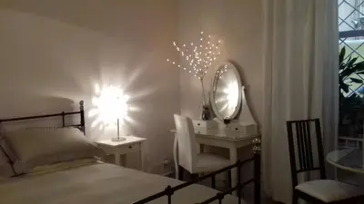 a bedroom with a bed and a desk with a mirror at Boezio43B&B in Rome