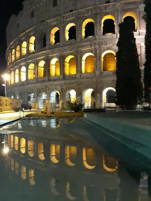 a building with a reflection in the water in front of it at Boezio43B&B in Rome