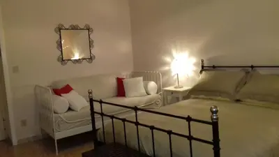 a bedroom with a bed and a chair and a mirror at Boezio43B&B in Rome