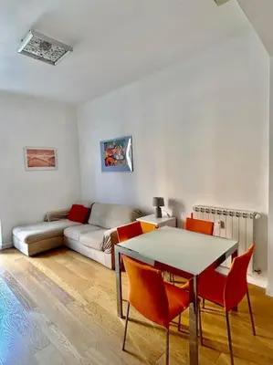 a living room with a couch and a table and chairs at Angel House - balcony and view in Rome