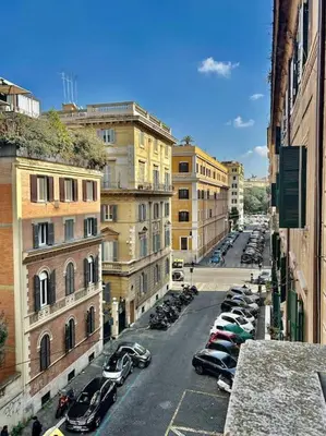 a city street with parked cars and buildings at Angel House - balcony and view in Rome