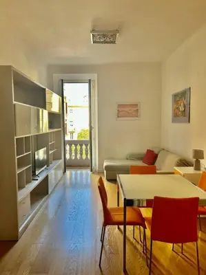 a living room with a table and chairs and a couch at Angel House - balcony and view in Rome