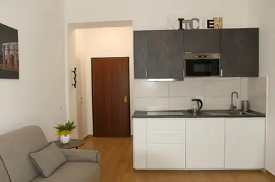 a kitchen with a sink and a couch in a room at Casa di Alice in Rome