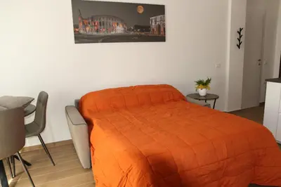 a bedroom with a bed with an orange blanket at Casa di Alice in Rome