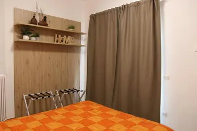 a bedroom with a bed and a window with a curtain at Casa di Alice in Rome