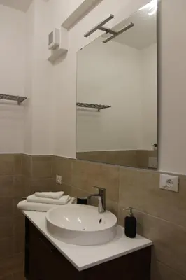a bathroom with a sink and a mirror at Casa di Alice in Rome