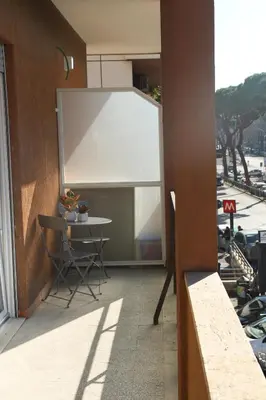 a balcony with a table and a whiteboard on a building at Casa di Alice in Rome