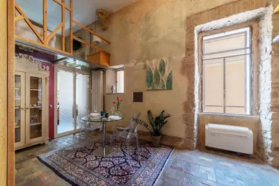 a room with a table and chairs and a window at Amazing & Romantic *Loft Testaccio Aventino* in Rome