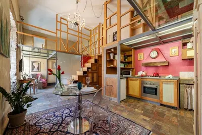 a kitchen with a table in the middle of a room at Amazing & Romantic *Loft Testaccio Aventino* in Rome