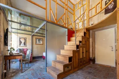 a staircase in a house with a glass entry door at Amazing & Romantic *Loft Testaccio Aventino* in Rome