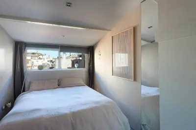 a small bedroom with a bed and a window at Panoramic Apartment Trastevere in Rome