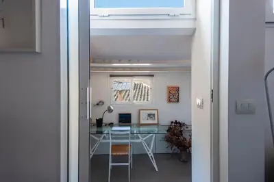 a room with a desk and a table at Panoramic Apartment Trastevere in Rome