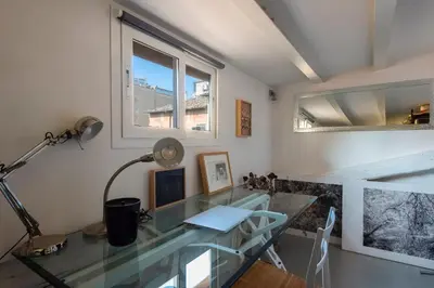 a glass desk in a room with a window at Panoramic Apartment Trastevere in Rome