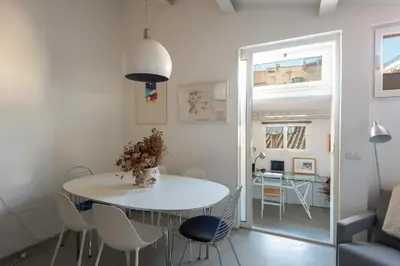 a white dining room with a white table and chairs at Panoramic Apartment Trastevere in Rome