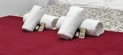 a group of rolled up towels on a bed at Stazione Telese 41 in Rome