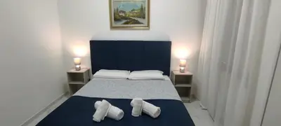 a bedroom with a bed with two pillows and two lamps at Stazione Telese 41 in Rome
