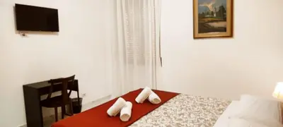 a bedroom with a bed with towels on a table at Stazione Telese 41 in Rome