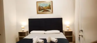 a bedroom with a bed with two towels on it at Stazione Telese 41 in Rome