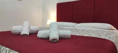 a bedroom with a bed with rolled towels on it at Stazione Telese 41 in Rome