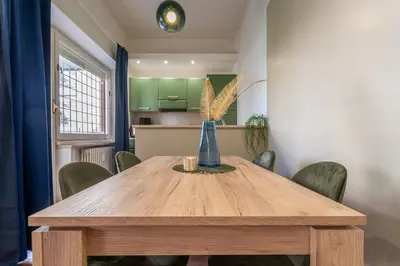 a dining room with a wooden table and chairs at Diana - Romantic Suite in Rome