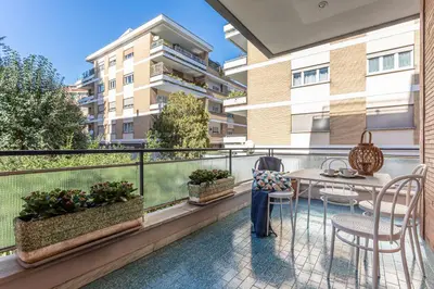 a balcony with a table and chairs on a building at Diana - Romantic Suite in Rome