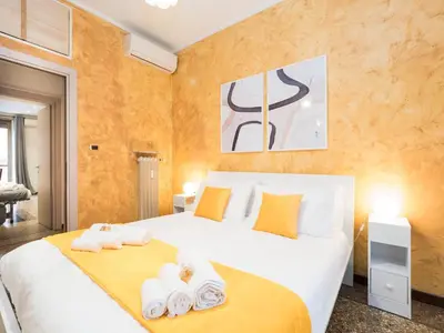 a bedroom with two beds with towels on them at {Colosseum 10 minutes} Netflix & Free Wi-Fi in Rome
