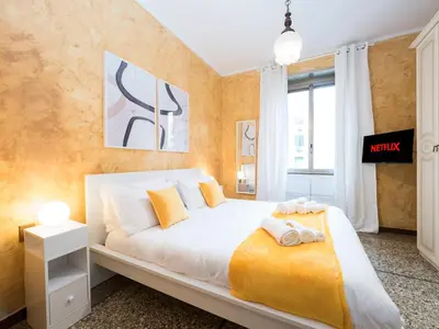 a bedroom with a large bed with orange walls at {Colosseum 10 minutes} Netflix & Free Wi-Fi in Rome