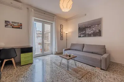 a living room with a couch and a table at Basilica San Giovanni 1Bedr 5 minut from Station in Rome