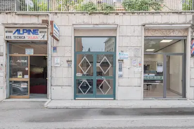 a store front with a blue door and windows at Basilica San Giovanni 1Bedr 5 minut from Station in Rome