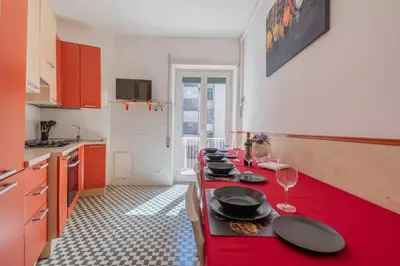 a kitchen with a red counter with plates on it at Basilica San Giovanni 1Bedr 5 minut from Station in Rome