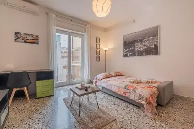 a bedroom with a bed and a tv and a table at Basilica San Giovanni 1Bedr 5 minut from Station in Rome