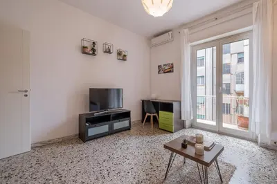 a living room with a television and a table at Basilica San Giovanni 1Bedr 5 minut from Station in Rome
