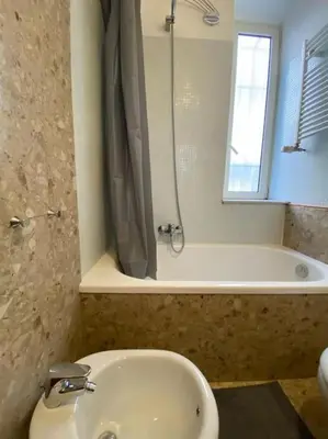 a bathroom with a toilet and a shower and a sink at Monteverde Suites in Rome