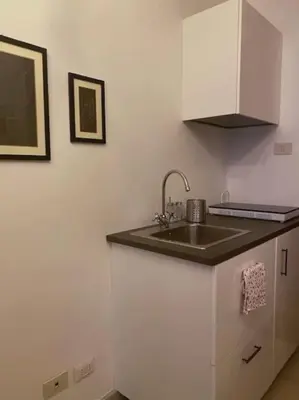 a kitchen with a sink and a counter top at Monteverde Suites in Rome