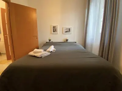 a bedroom with a bed with two towels on it at Monteverde Suites in Rome