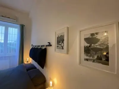a bedroom with a blue couch and a window at Monteverde Suites in Rome