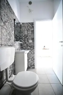 a bathroom with a white toilet and a sink at QUEEN VATICAN in Rome