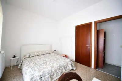 a bedroom with a bed and a wooden cabinet at QUEEN VATICAN in Rome