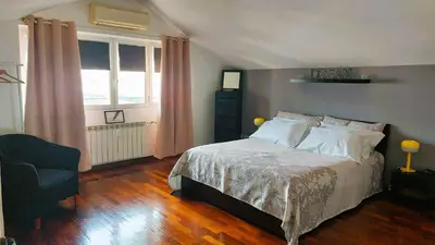 a bedroom with a bed and a chair and a window at Aroma Vaticano - Appartamento a San Pietro in Rome