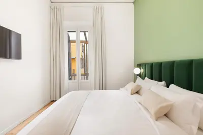 a bathroom with a white sink and a mirror at At Twenty-nine - NUOVO e incantevole appartamento! in Rome