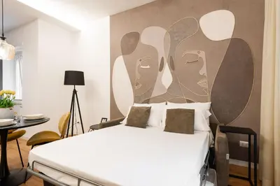 a bedroom with a bed with a painting on the wall at Ascanio's Cozy Apartment - by 101Flats in Rome