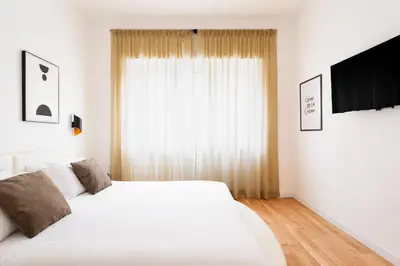 a bedroom with a large white bed and a window at Ascanio's Cozy Apartment - by 101Flats in Rome