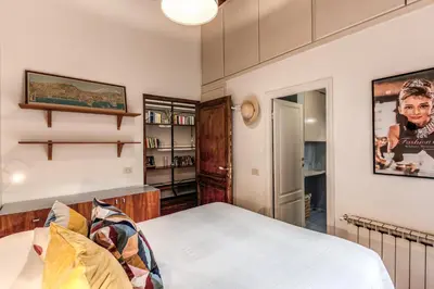 a bedroom with a bed and a book shelf at Trastevere Design & Comfort in Rome