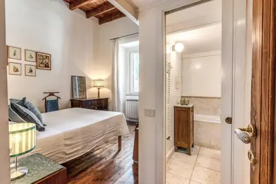 a bedroom with a bed and a bathroom at Trastevere Design & Comfort in Rome