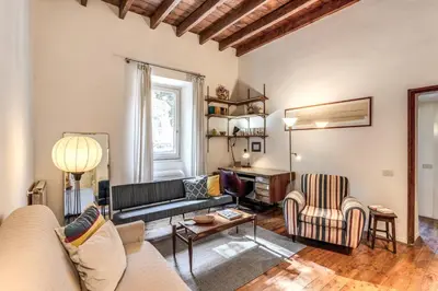 a living room with a couch and two chairs at Trastevere Design & Comfort in Rome