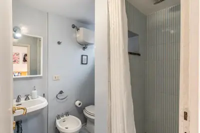 a bathroom with a toilet and a sink and a shower at Trastevere Design & Comfort in Rome