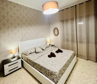 a bedroom with a bed with two shoes on it at Apartment Albona 77 in Rome