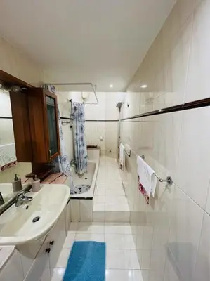 a white bathroom with a sink and a tub at Apartment Albona 77 in Rome